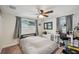 Bedroom with a fan, two windows for natural light, and carpeted floors at 7740 Bracken Dr, Port Richey, FL 34668