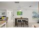 Cozy dining area with stylish seating, and an open view of the living room at 7740 Bracken Dr, Port Richey, FL 34668