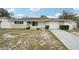 Charming single-story home features a well-maintained lawn, neutral paint, and an attached garage at 7740 Bracken Dr, Port Richey, FL 34668