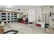 This garage features an automatic door, storage cabinets, pegboard, and utility storage at 7740 Bracken Dr, Port Richey, FL 34668