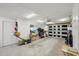The well-lit garage has cabinets, storage space, and an automatic door at 7740 Bracken Dr, Port Richey, FL 34668