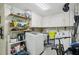 This laundry room features modern washer and dryer units, storage cabinets, and shelving at 7740 Bracken Dr, Port Richey, FL 34668