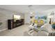 Cozy living room features an entertainment center with modern speakers, tile flooring, and comfortable seating at 7740 Bracken Dr, Port Richey, FL 34668
