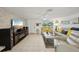 Cozy living room features an entertainment center with modern speakers, tile flooring, and comfortable seating at 7740 Bracken Dr, Port Richey, FL 34668