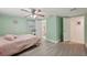 Main bedroom with ceiling fan, access to a private bath, and a neutral color palette at 7740 Bracken Dr, Port Richey, FL 34668
