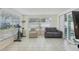 Bright sunroom with tile floors and ample natural light offers a versatile space for relaxation at 7740 Bracken Dr, Port Richey, FL 34668