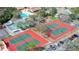 Aerial view of community tennis courts offering a vibrant recreational space for residents and guests alike at 8216 Mill Creek Ln, Hudson, FL 34667