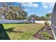 Fenced backyard with a storage shed, landscaping beds, and a view of mature trees at 8942 Aberdeen Creek Cir, Riverview, FL 33569