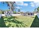 Large backyard with a shed, privacy fence, screened pool enclosure, and generous green space at 8942 Aberdeen Creek Cir, Riverview, FL 33569