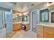 This is a primary bathroom with dual sinks, a window, and a glass-enclosed shower at 8942 Aberdeen Creek Cir, Riverview, FL 33569