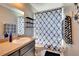 This is a bathroom with a vanity, mirror, toilet, and shower with a blue curtain at 8942 Aberdeen Creek Cir, Riverview, FL 33569