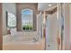 This is a primary bathroom featuring a soaking tub and a glass-enclosed shower at 8942 Aberdeen Creek Cir, Riverview, FL 33569