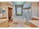 This is a primary bathroom with a soaking tub, window, and glass-enclosed shower at 8942 Aberdeen Creek Cir, Riverview, FL 33569