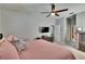 This is a primary bedroom with gray walls, a ceiling fan, and an ensuite bathroom at 8942 Aberdeen Creek Cir, Riverview, FL 33569