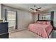 Cozy bedroom featuring a ceiling fan and windows allowing ample natural light at 8942 Aberdeen Creek Cir, Riverview, FL 33569