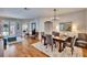 Open-concept dining room featuring wood floors, modern chandelier, and neutral decor with lots of space at 8942 Aberdeen Creek Cir, Riverview, FL 33569