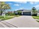 Charming home showcasing an extended driveway, manicured landscaping, and attached two-car garage at 8942 Aberdeen Creek Cir, Riverview, FL 33569