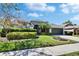 Charming single-story home featuring manicured landscaping, a two-car garage, and a welcoming front entrance at 8942 Aberdeen Creek Cir, Riverview, FL 33569