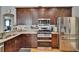 Spacious kitchen featuring stainless steel appliances, granite countertops, and ample cabinet storage space at 8942 Aberdeen Creek Cir, Riverview, FL 33569