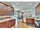 Open kitchen with dark cabinetry, granite countertops, stainless steel appliances, and a view of the pool at 8942 Aberdeen Creek Cir, Riverview, FL 33569