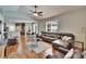 Open-concept living room features modern decor and seamlessly connects to the kitchen and dining area at 8942 Aberdeen Creek Cir, Riverview, FL 33569