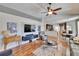 Open living area featuring modern entertainment center and direct access to kitchen and dining areas at 8942 Aberdeen Creek Cir, Riverview, FL 33569