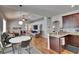 Open floorplan featuring a kitchen, dining area, and living room with vaulted ceilings and a ceiling fan at 8942 Aberdeen Creek Cir, Riverview, FL 33569