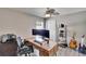 This is an office with a wood desk, dual monitors, and gray wood-look flooring at 8942 Aberdeen Creek Cir, Riverview, FL 33569