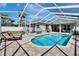 Relaxing screened-in pool area with brick pavers, lush landscaping and lounge seating at 8942 Aberdeen Creek Cir, Riverview, FL 33569