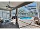 Outdoor screened-in pool area with stone pavers and ample seating space for guests at 8942 Aberdeen Creek Cir, Riverview, FL 33569