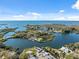 Areal view of a waterfront community featuring private docks and lush greenery on a sunny day at 9017 Petal Ct, Hudson, FL 34667