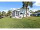 Backyard with a waterfront view, lush green grass, boat dock, and landscaping at 9017 Petal Ct, Hudson, FL 34667