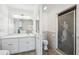 Bathroom featuring vanity with white cabinets and walk-in shower with mermaid etched glass door at 9017 Petal Ct, Hudson, FL 34667
