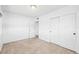 Bedroom with terrazzo floors, closet, and access to another room at 9017 Petal Ct, Hudson, FL 34667