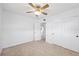 Bedroom with terrazzo floors, ceiling fan and closet storage space at 9017 Petal Ct, Hudson, FL 34667