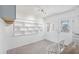 Bright dining room with shelving, natural light, and a decorated entry door at 9017 Petal Ct, Hudson, FL 34667
