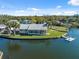 Waterfront home on grassy lot with screened porch and private dock on a clear day at 9017 Petal Ct, Hudson, FL 34667