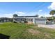 Charming single-story home featuring solar panels, boat storage, and a well-maintained front lawn at 9017 Petal Ct, Hudson, FL 34667