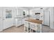 Bright kitchen with white cabinets, center island, and stainless steel appliances at 9017 Petal Ct, Hudson, FL 34667
