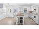 Bright kitchen with white cabinets, center island, and stainless steel appliances at 9017 Petal Ct, Hudson, FL 34667