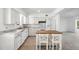 Bright kitchen features white cabinetry, stainless appliances, and an island with seating at 9017 Petal Ct, Hudson, FL 34667
