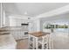 Bright kitchen with white cabinets, center island, and stainless steel appliances at 9017 Petal Ct, Hudson, FL 34667