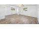 Spacious living room with light, bright interior featuring wood-look floors and ceiling fan at 9017 Petal Ct, Hudson, FL 34667