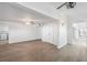 Open living area with ceiling fan, closet and access to the kitchen at 9017 Petal Ct, Hudson, FL 34667