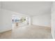 Open-concept living room with access to a sunroom with beautiful views at 9017 Petal Ct, Hudson, FL 34667