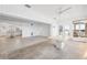 An expansive living area leads to a sunroom and modern kitchen at 9017 Petal Ct, Hudson, FL 34667
