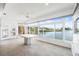 The sunroom features tiled floors, a ceiling fan, and waterfront views at 9017 Petal Ct, Hudson, FL 34667