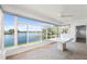 Waterfront sunroom with an oversized glass window, fan, and tile flooring at 9017 Petal Ct, Hudson, FL 34667