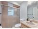 Cozy bathroom featuring a shower with glass doors, pink tiles, and vanity with sink at 902 Marco Ne Dr, St Petersburg, FL 33702