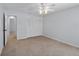 This bedroom offers neutral carpet, ceiling fan, and a closet at 902 Marco Ne Dr, St Petersburg, FL 33702